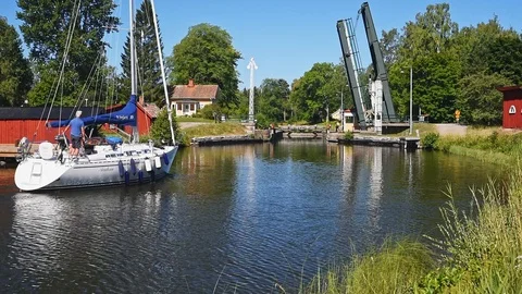 Sailboat approaching open bascule bridge on Gota canal Stock Footage 95932159
