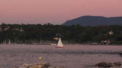 A sailboat bobs in the water during a dramatic Geneva Sunset Stock Footage 89294887