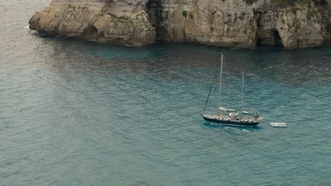 Sailboat in Cala Macarella during a windy day, Minorca, Balearic Islands Stock Footage 303752636