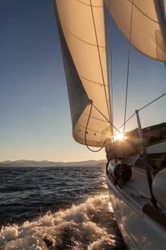 Sailboat crop at sunset ocean Stock Photos