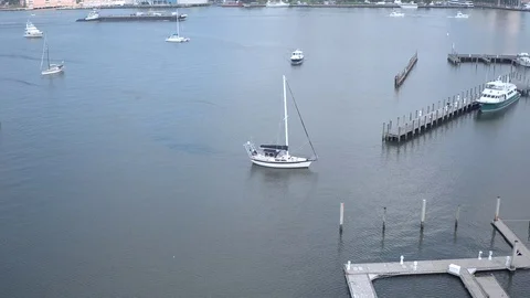 Sailboat entering harbor Stock Footage 117431475