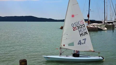 Sailboat exits the harbor Stock Footage 311574621