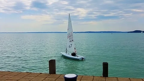 Sailboat exits the harbor 스톡 동영상 311761608