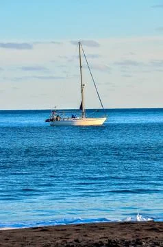 A sailboat is floating on the ocean Stock Photos