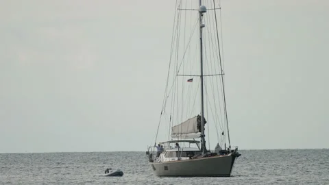 Sailboat floating to shore Stock Footage 229527192