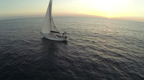 A sailboat floating at sunset 库存影片 35680533