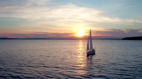 Sailboat Floating on Water During Sunset by Aerial Drone  Stock Footage 65044892