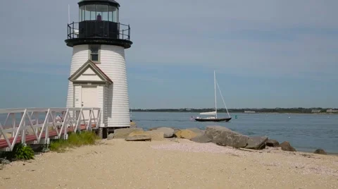 Sailboat Gliding by a Nantucket Lighthouse on a Cloudy Day 스톡 동영상 59712171
