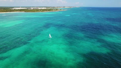 Sailboat gliding over deep blue Caribbean waters near the coastline in Mexico Video stock 341449975