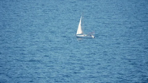 Sailboat gracefully navigating tranquil blue waters on a sunny day Video stock 292264044