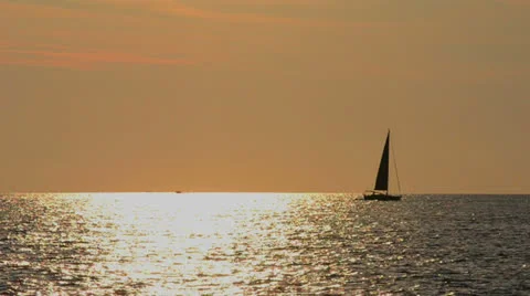 Sailboat on the horizon at sunset Stock Footage 24832415