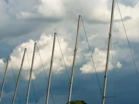 Sailboat masts against the clouds Stock Photos