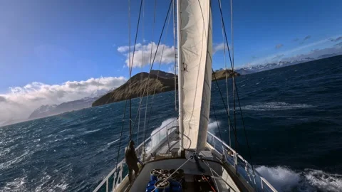 Sailboat navigating rough seas during an ocean voyage Stock Footage 335498078