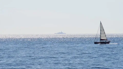 Sailboat passes on the sea full of reflections Stock Footage 89566845