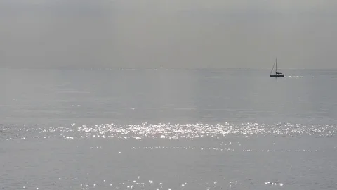 Sailboat propelled by the motor sails on the quiet sea Stock-Footage 83540630