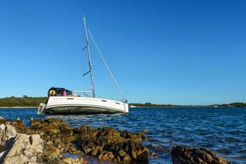 Sailboat on the rocks Stock Photos