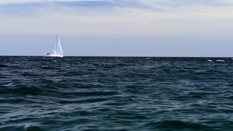 Sailboat on rough ocean waves Stock Footage 109364713