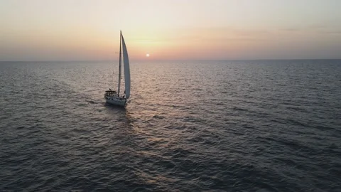 Sailboat sailing alone at sunset Stock Footage 167701795