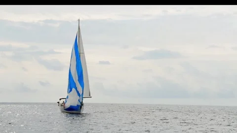 A sailboat is sailing on a cloudy day Stock Footage 275641374