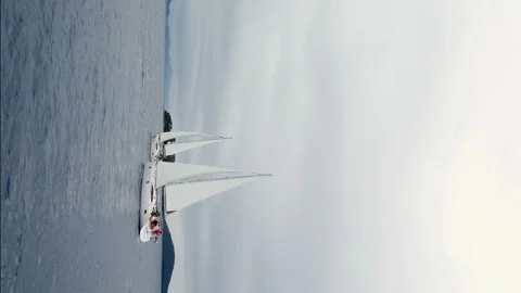 A sailboat is sailing in the ocean with a cloudy sky in the background Stock Footage 276072370