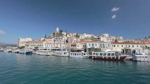 Sailboat sails behind the seafront of island Stock Footage 74095082