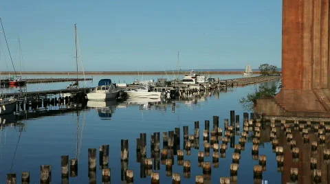 Sailboat sails into harbor Stock Footage 713774