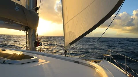 Sailboat with sails open cruising at sunset Video stock 59163128