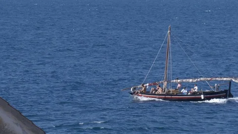 The sailboat sails the sea breaking the waves in the summer time Video stock 117353493