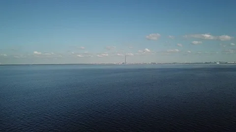 Sailboat slowly appears in the frame on the background of the city on open sea Stock Footage 116418054