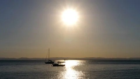 Sailboat standing in front of sun by sunset sunrise Stock Footage 125068060