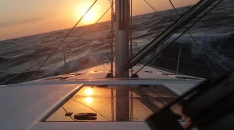 Sailboat in strong wind and big waves at sunset Video stock 67646002