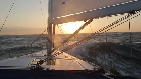 Sailboat in strong wind and big waves at sunset Video stock 67646014