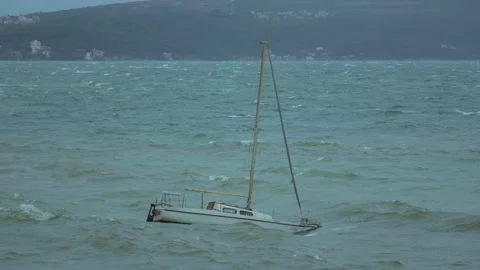 Sailboat struggles against waves in during a storm Stock Footage 313731419