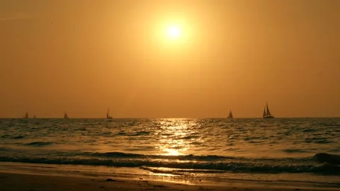 Sailboat at sunset on a beautiful beach Stock Footage 139498046
