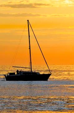 Sailboat at sunset Stock Photos