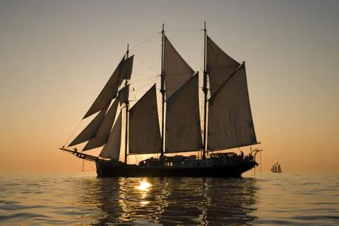 Sailboat at sunset Stock Photos