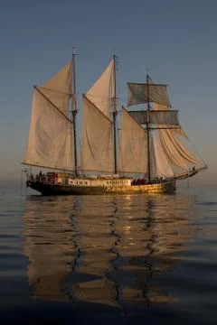 Sailboat at sunset Stock Photos