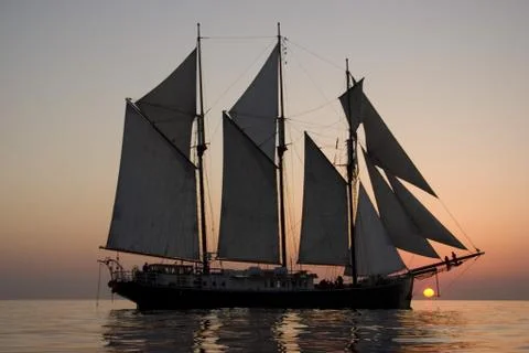 Sailboat at sunset Stock Photos