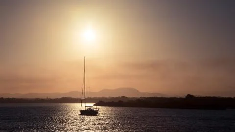 Sailboat at sunset Stock Photos
