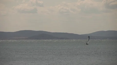 Sailboat surfs in the bay Stock-Footage 73797141