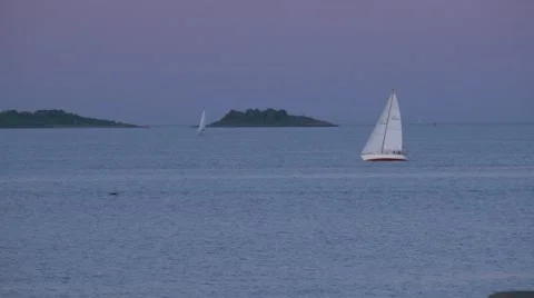 Sailboat  tacks right to left at dusk in Salem Massachusetts 4k Stock Footage 41607481
