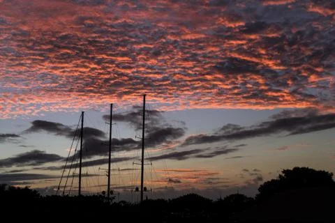 A sailboat under a sunset in Polynesia Stock Photos