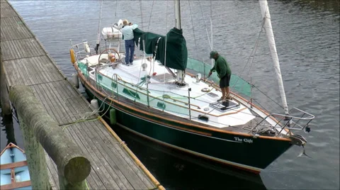 Sailboat washing at dock Stock Footage 30492430