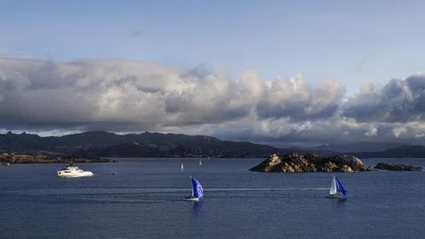 Sailboats and dramatic clouds, evening in the Mediterranean sea, La Maddalena Stock Photos