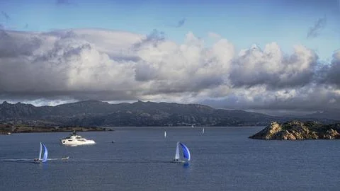 Sailboats and dramatic clouds, evening in the Mediterranean sea, La Maddalena Stock Photos
