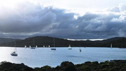 Sailboats and dramatic clouds, evening in the Mediterranean sea, La Maddalena Stock Photos
