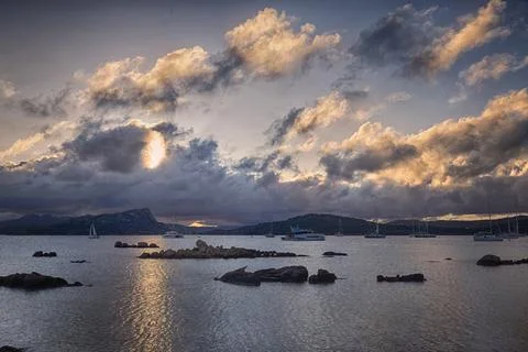 Sailboats and dramatic clouds, evening in the Mediterranean sea, La Maddalena Stock Photos