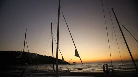 Sailboats on the beach at sunset. Time lapse. Stock Footage 8963264