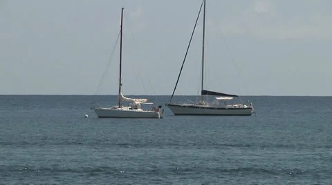 Sailboats floating on ocean Stock Footage 30683219