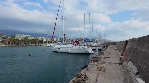 Sailboats moored in empty marina under cloudy sky before rain Stock Footage 337458726